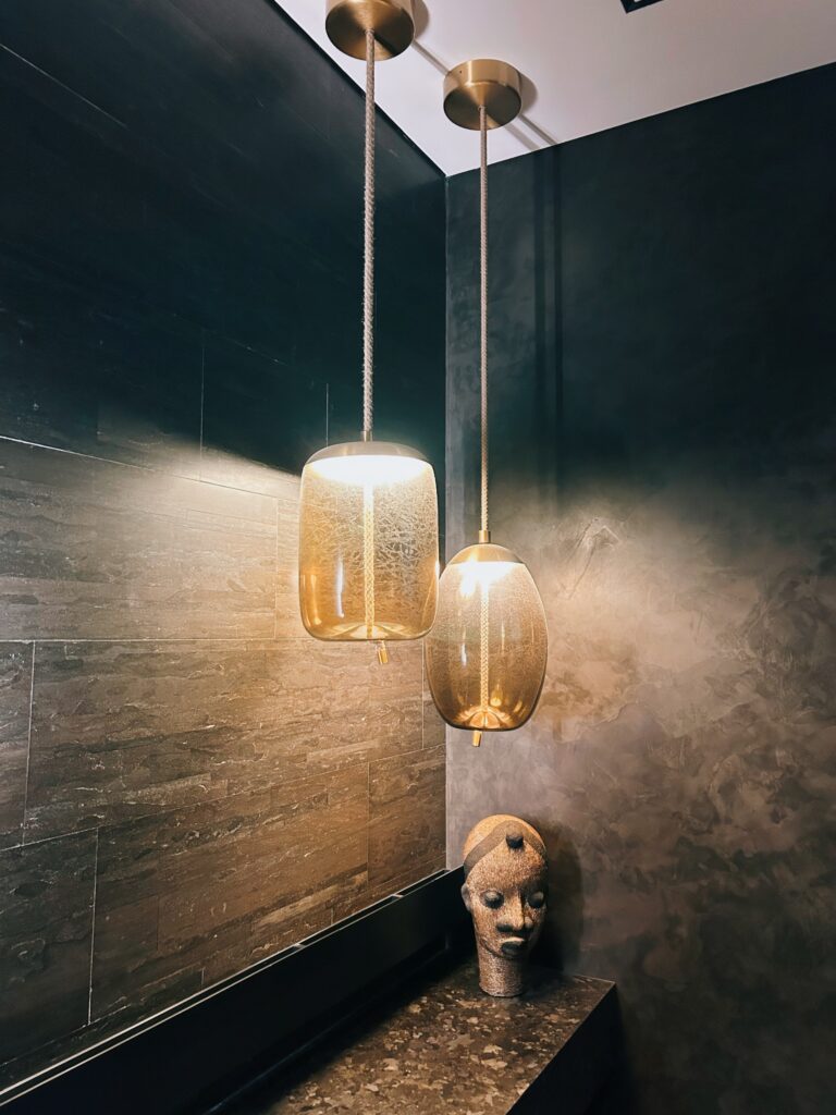Custom lighting over marble top with aztec head