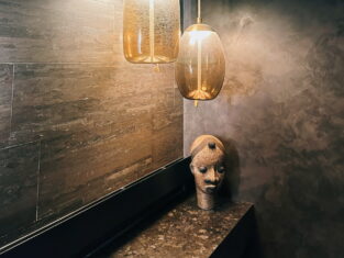 Custom lighting over marble top with aztec head