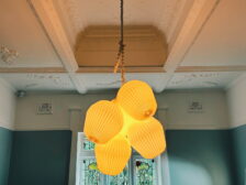 large custom lights hanging from an imprinted ceiling